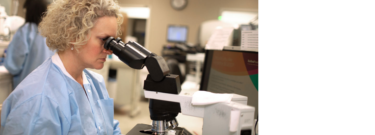 Woman using microscope in a laboratory
