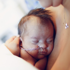 photo: newborn Ellie sleeping on mother's chest