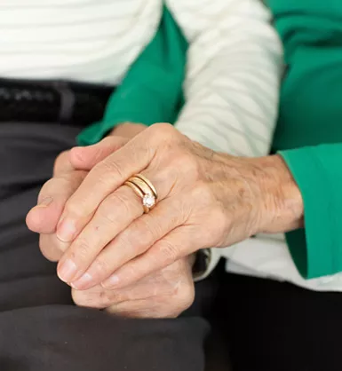 Photo of an older married couple holding hands