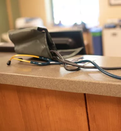 Stethoscope and blood pressure cuff sitting on counter