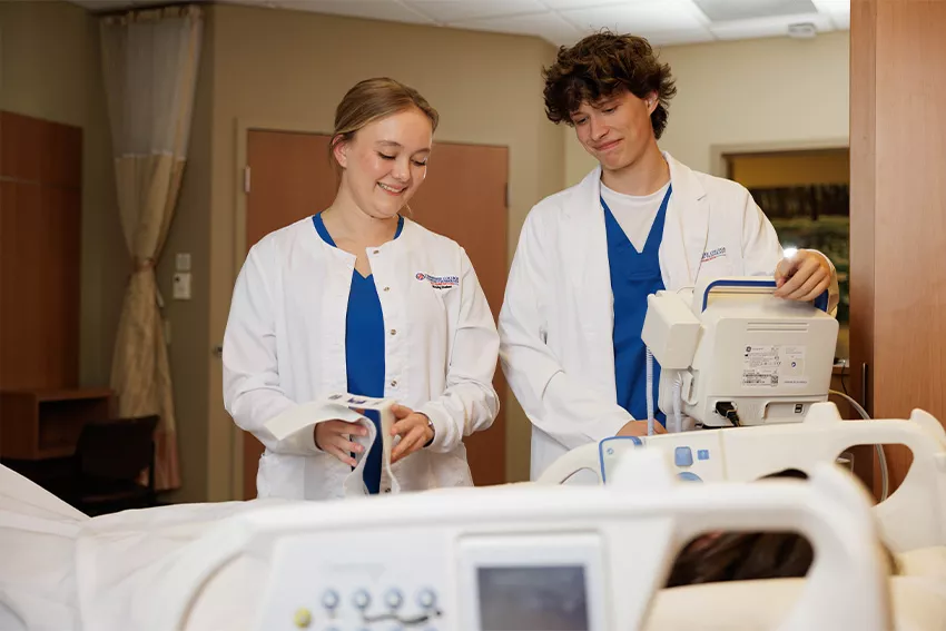 Two nurses at patient bedside